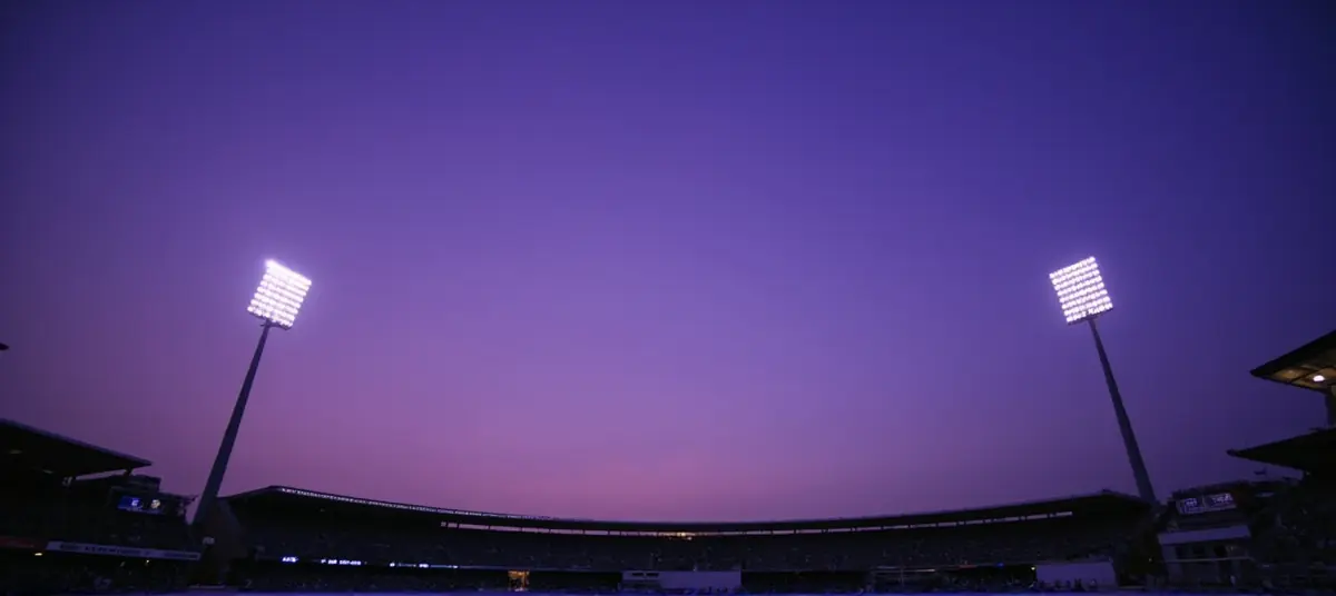 Floodlights at a stadium pylon at dusk